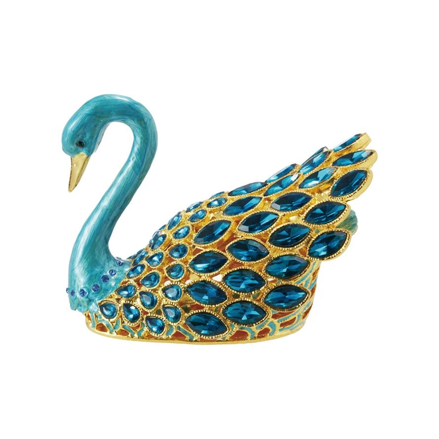 Decorative swan figurine with blue gemstones on a white background