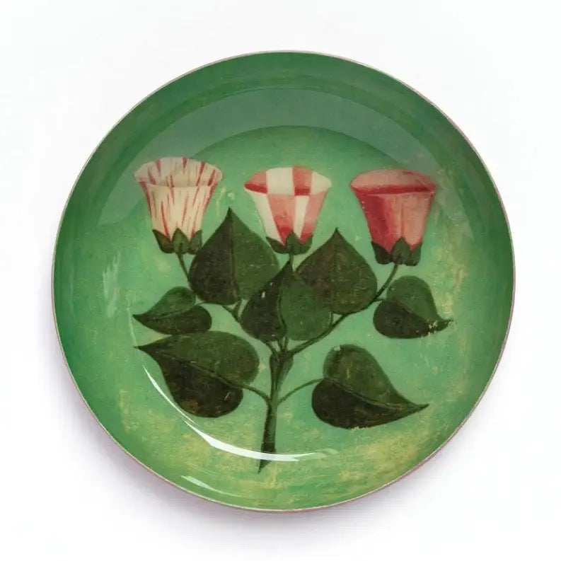 Decorative plate with floral design on a green background