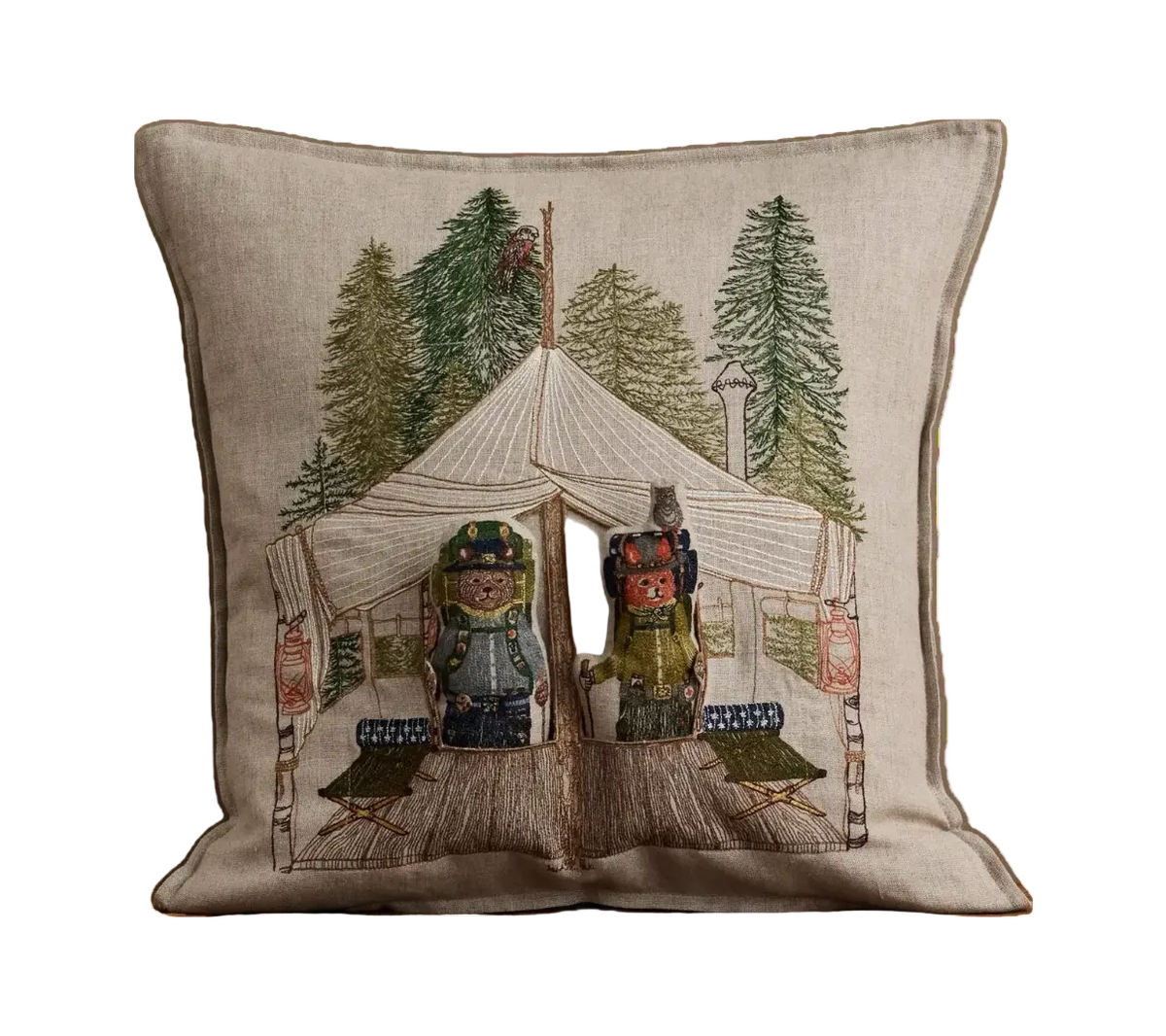 A square beige linen throw pillow featuring a detailed embroidered design of a vintage camping scene with two teddy bears under a large tent surrounded by pine trees.