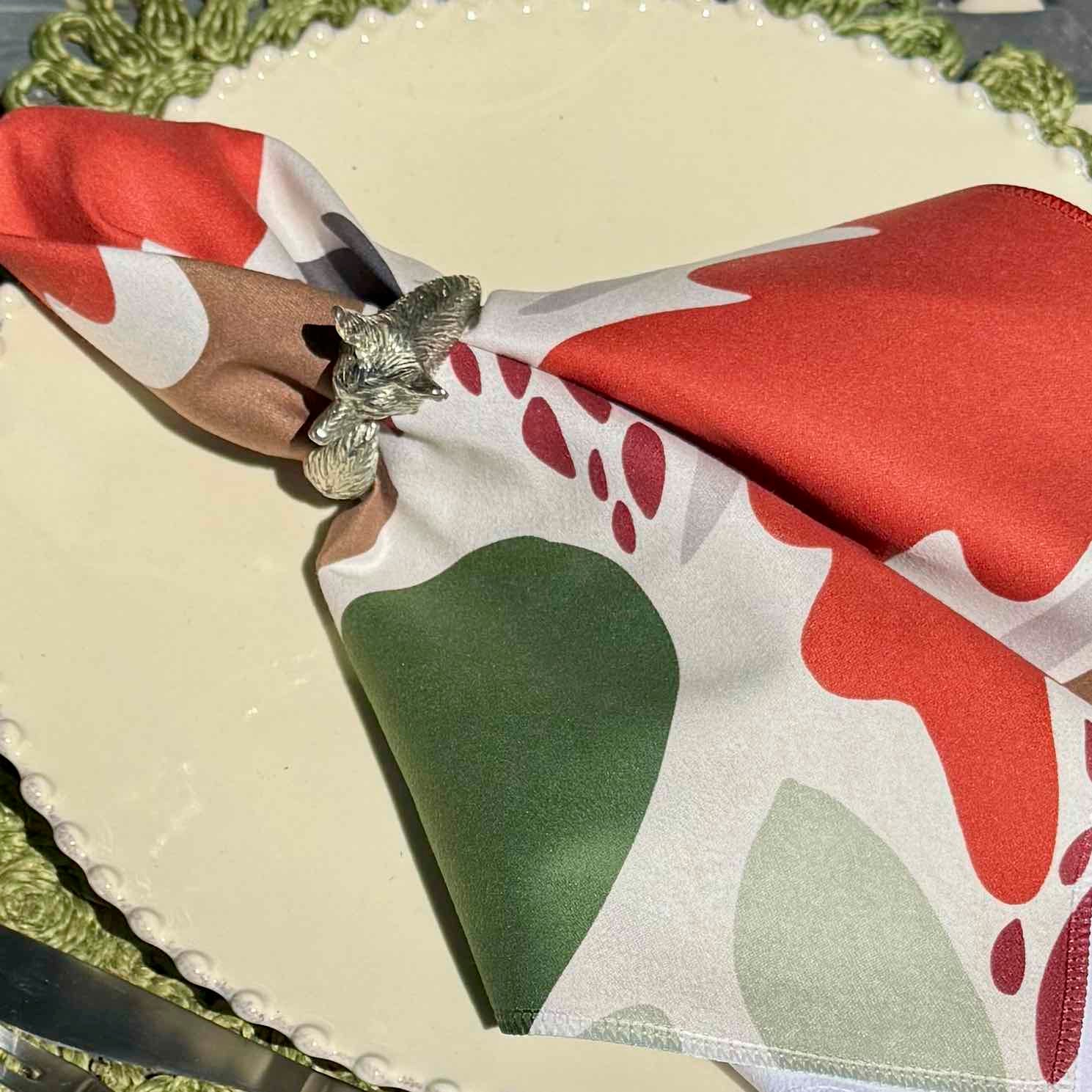 Napkin with red and green pattern on a table setting