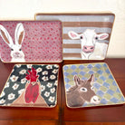 Four animal-themed coasters on a wooden surface