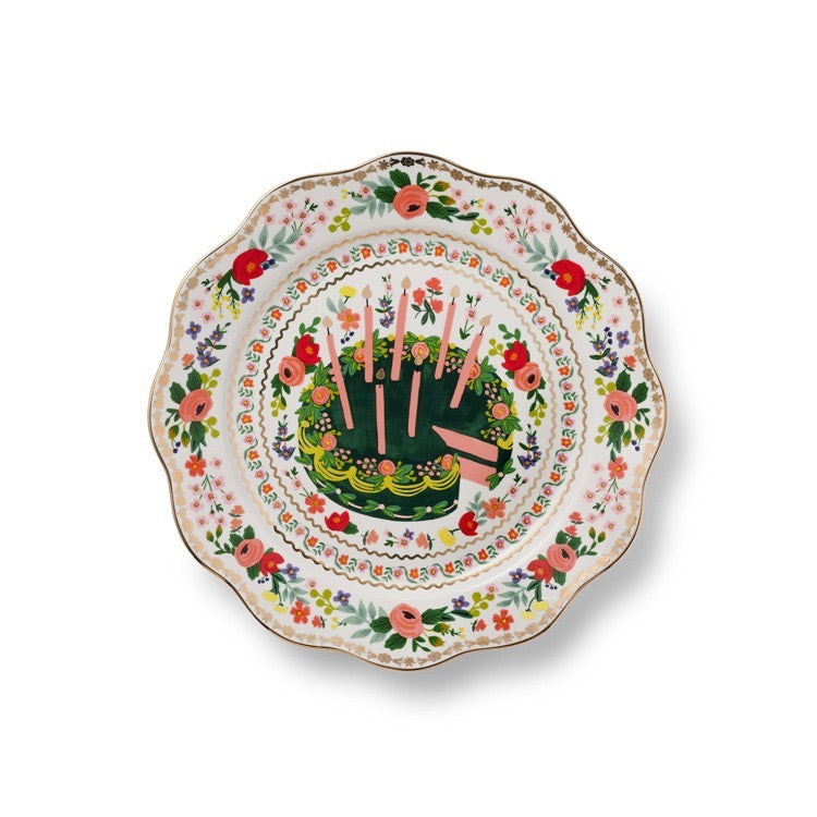 Decorative plate with floral design and cake illustration on a white background