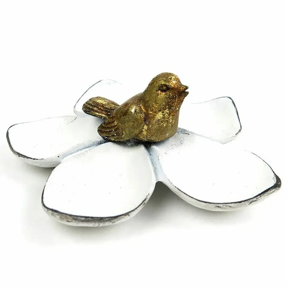 Decorative item with a gold bird on a white flower on a white background