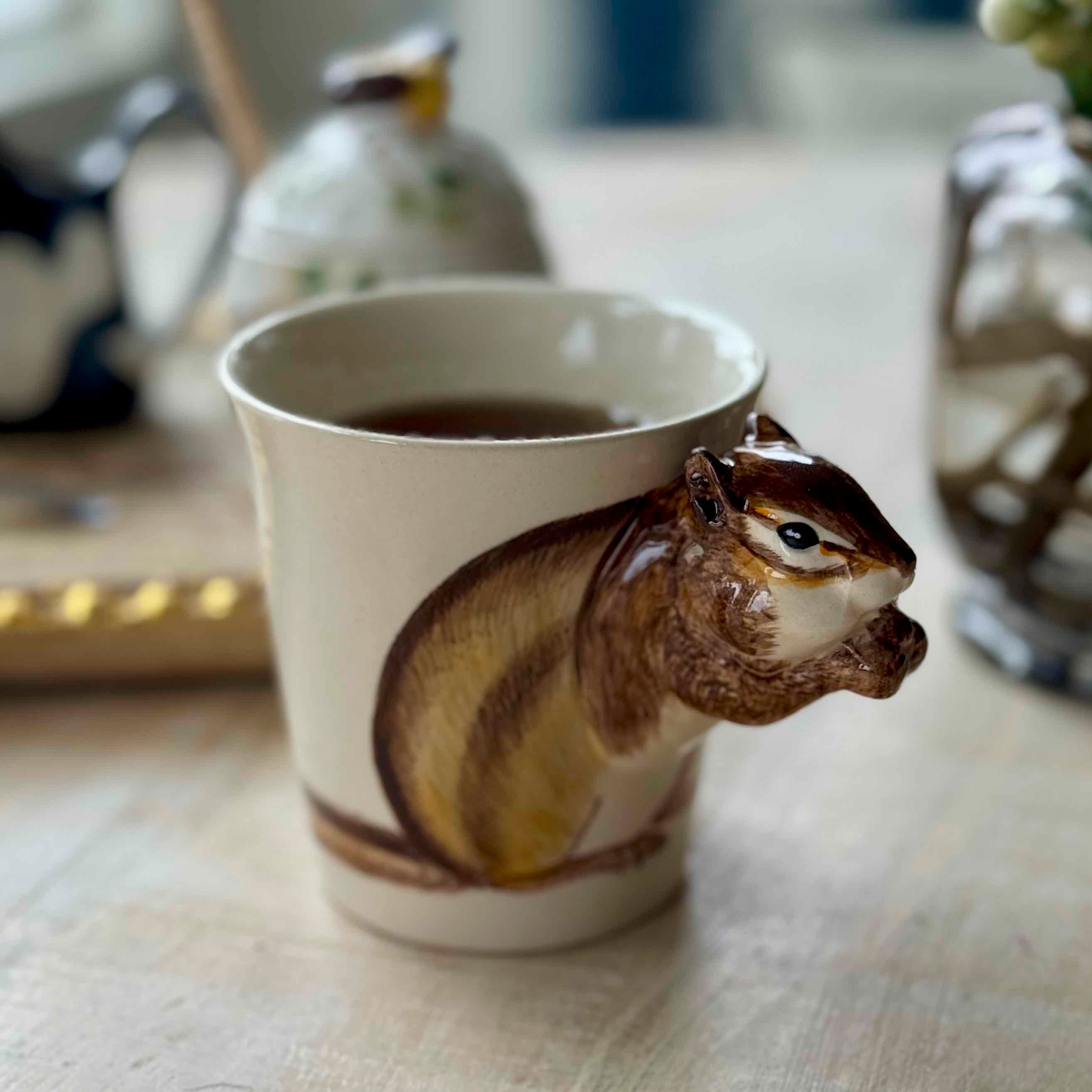 Squirrel-shaped mug with a handle on a table