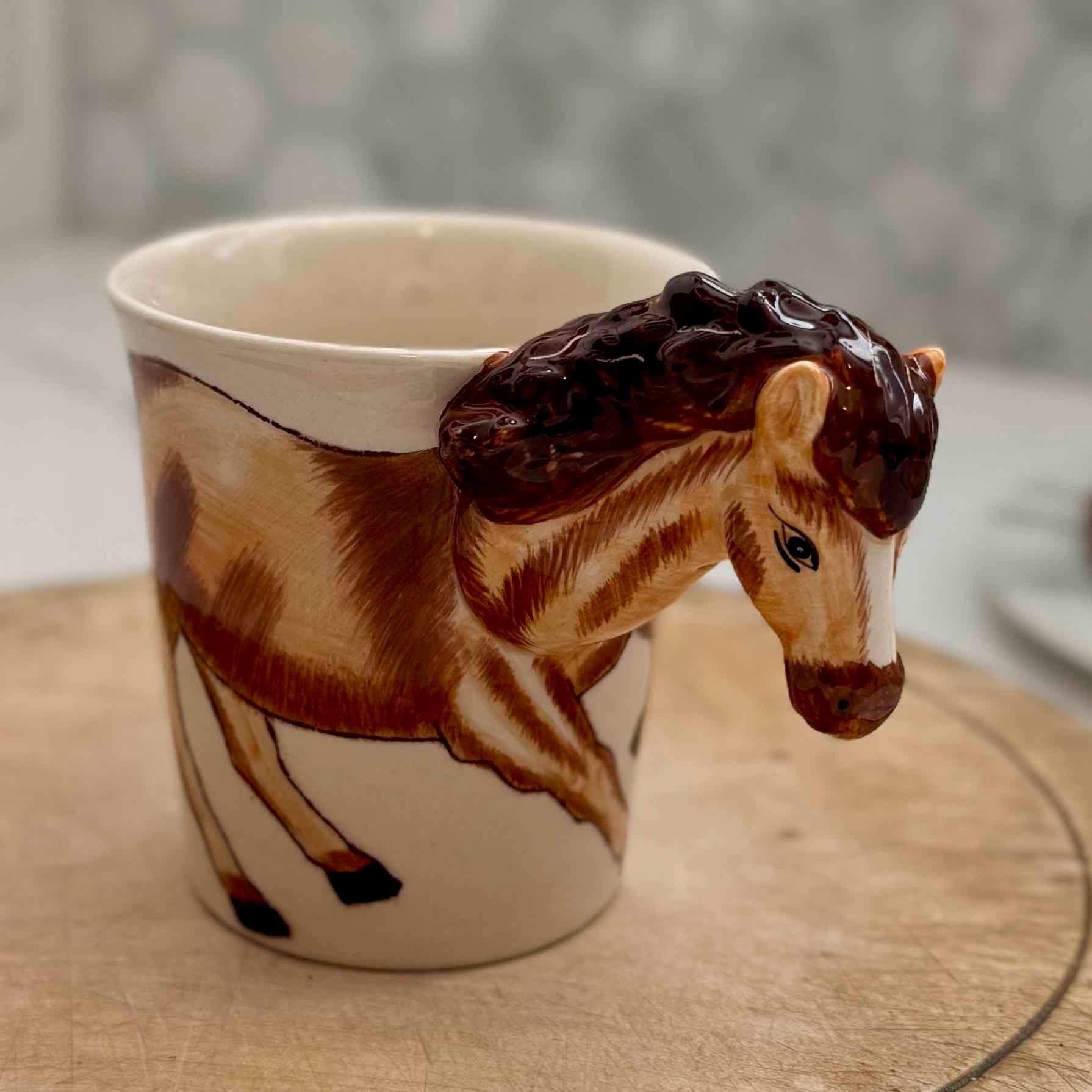Mug with a horse design on a wooden surface