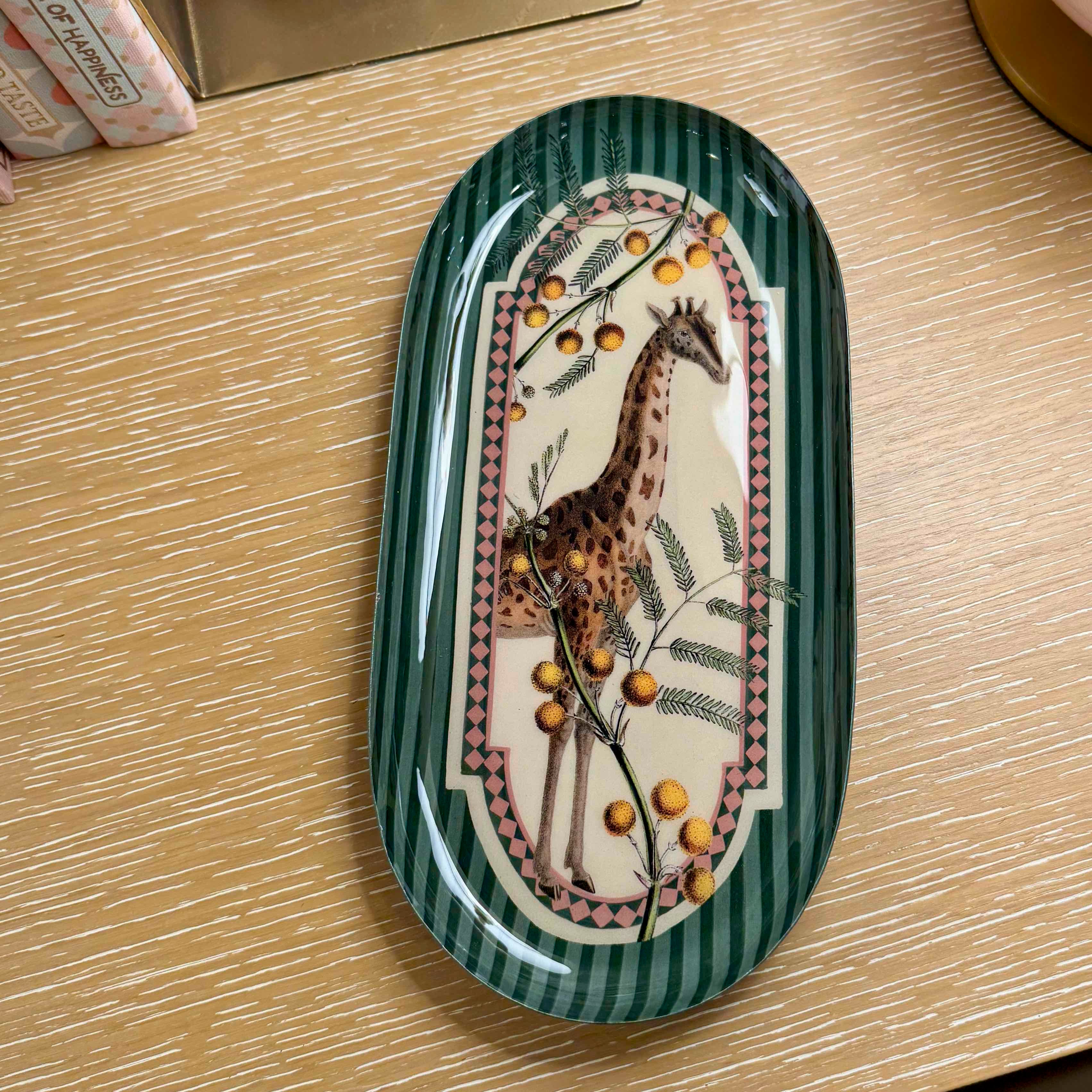 Decorative tray with a giraffe design on a wooden surface