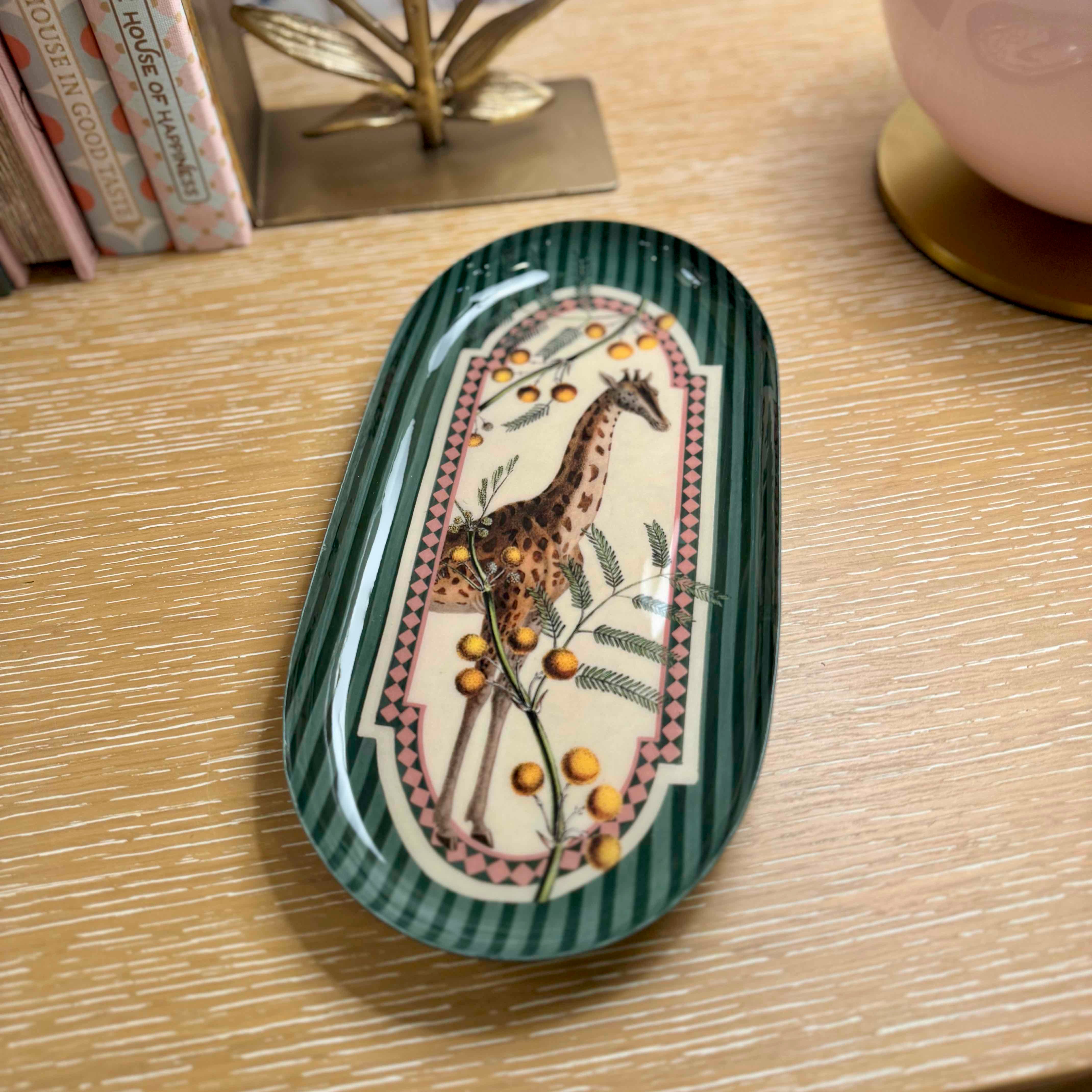 Decorative tray with a giraffe design on a wooden surface