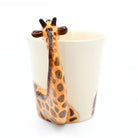 Giraffe-shaped ceramic spoon rest on a white background