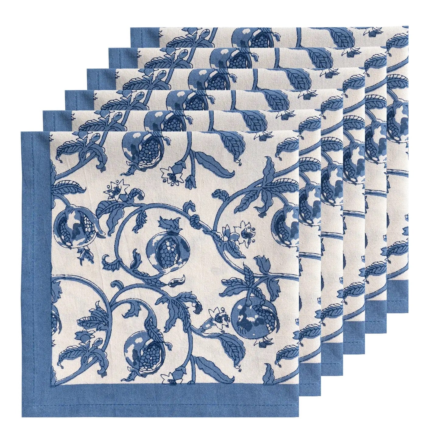 Set of six blue and white patterned napkins on a white background