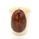 Ceramic avocado-shaped object on a white background