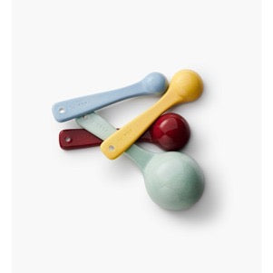 Colorful measuring spoons on a white background