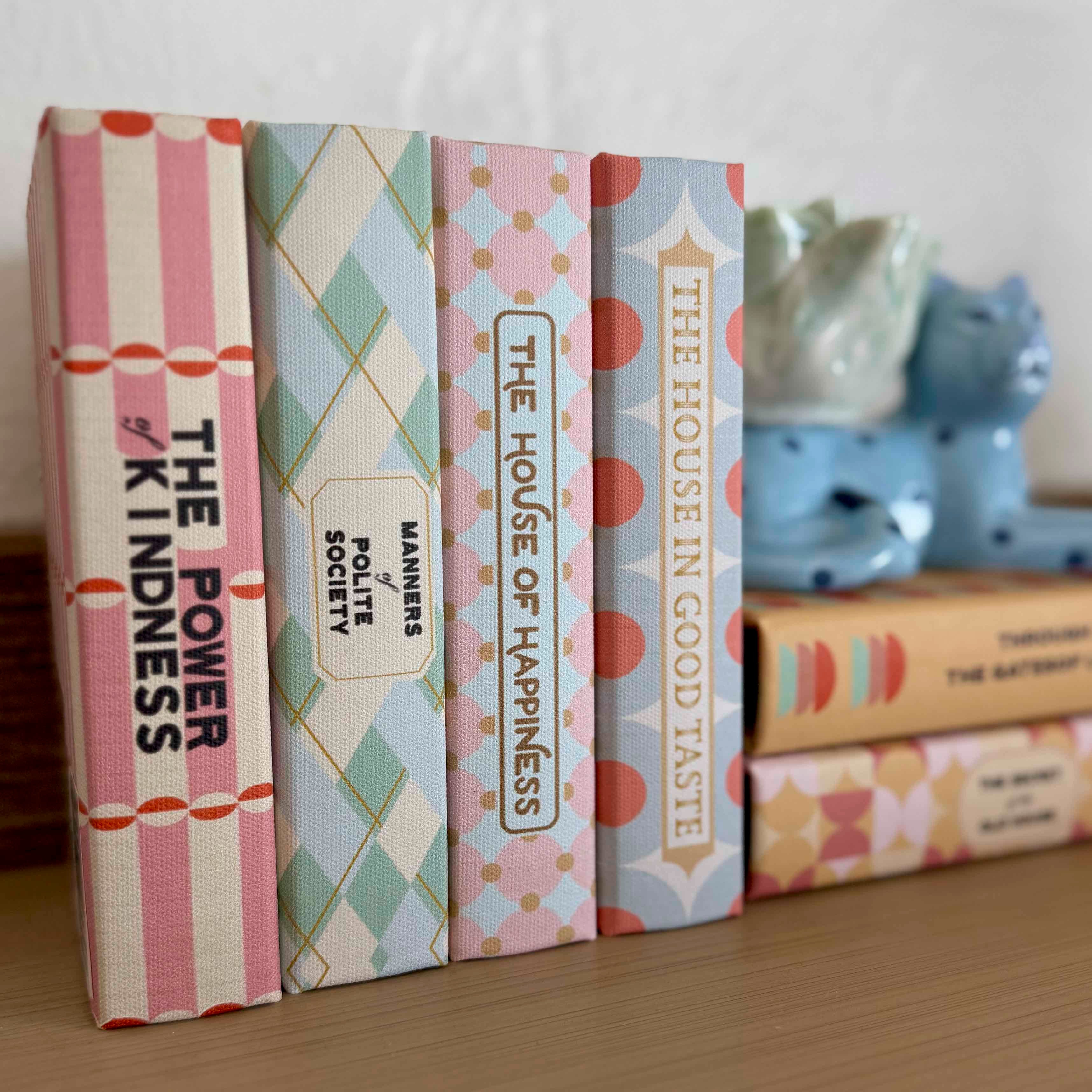 Set of books with decorative covers on a wooden surface