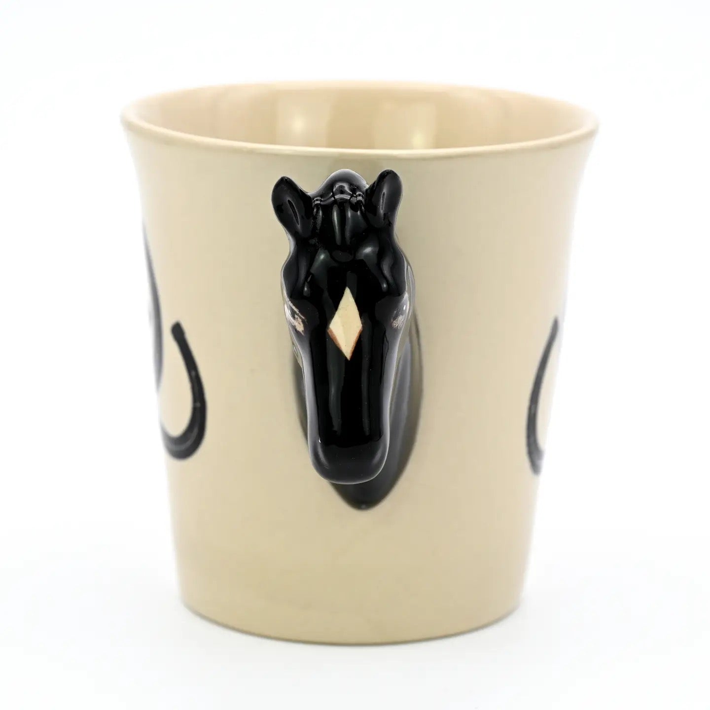 Beige mug with black horse head handle on a white background