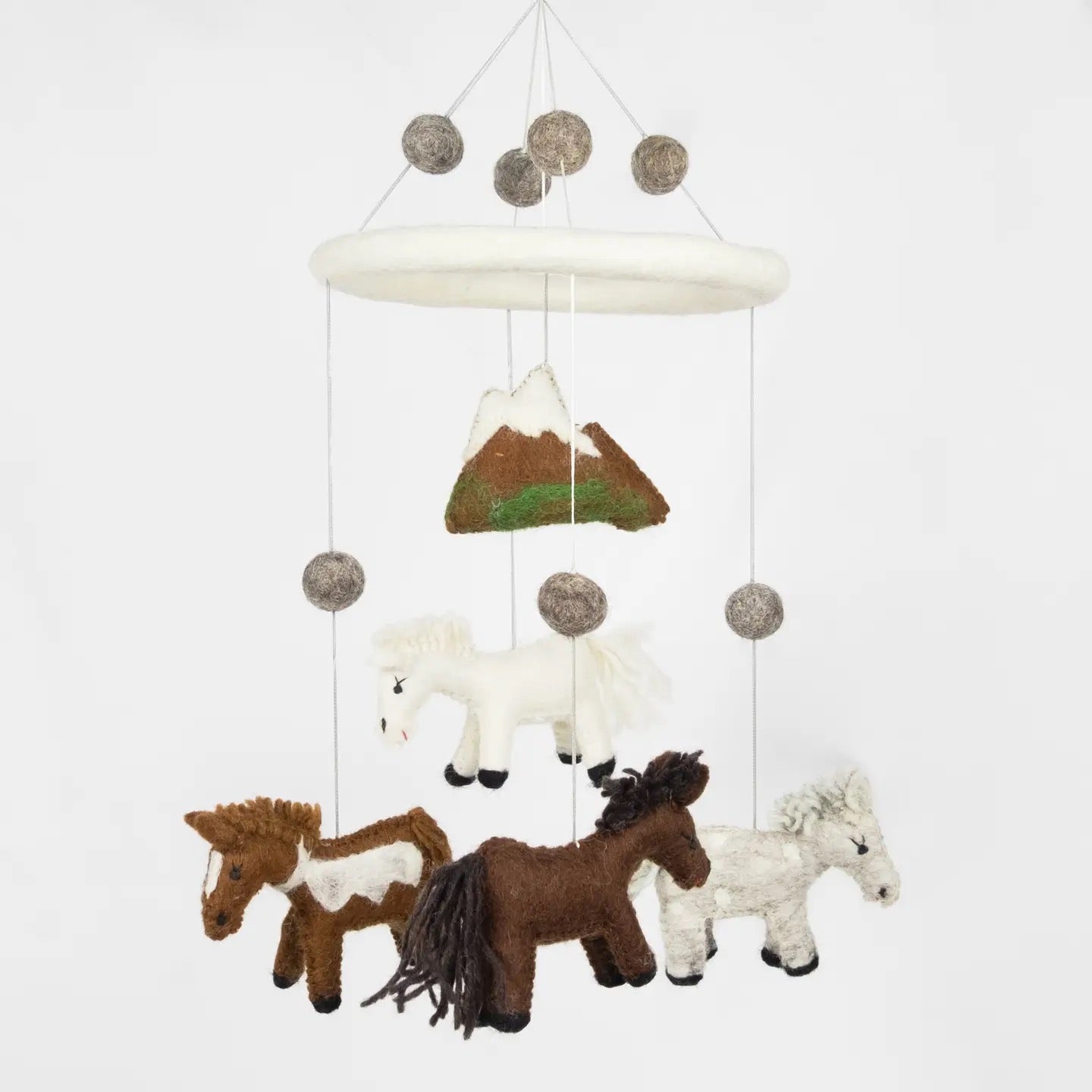 Plush horse mobile with mountains on a white background