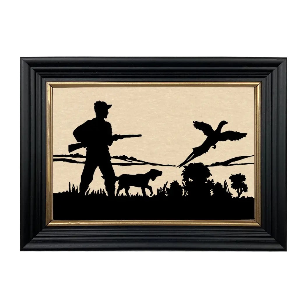 Framed artwork of a hunter with a dog and a duck in silhouette against a beige background.