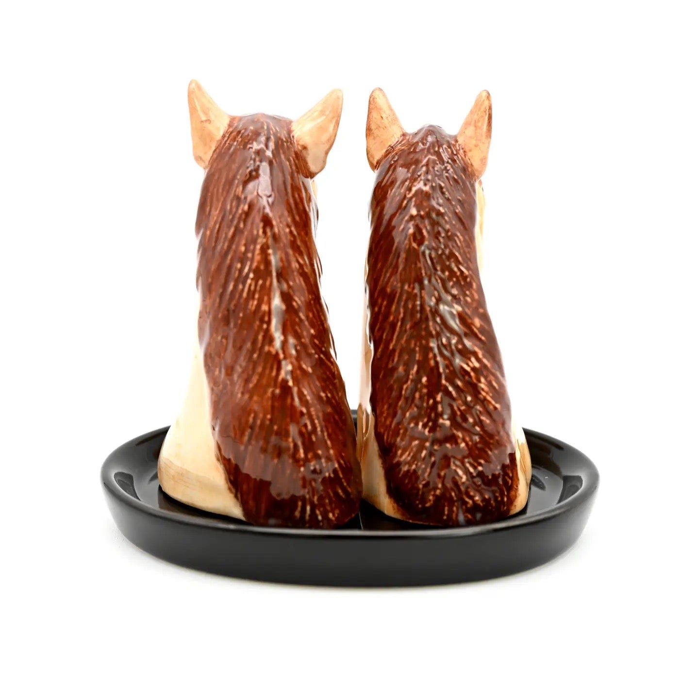 Horse-shaped salt and pepper shakers on a black base with a white background