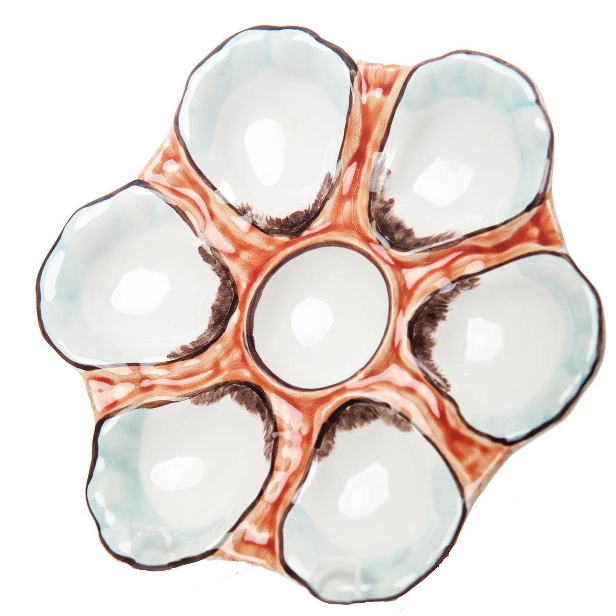 Close-up of a ceramic egg tray with six compartments on a white background