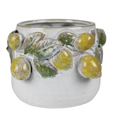 A white ceramic planter pot featuring a raised relief design of yellow-green berries and green leaves, isolated on a white background.