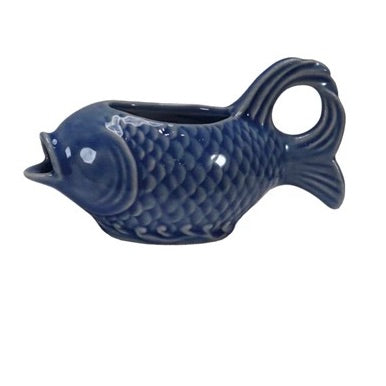 Blue ceramic fish-shaped container on a white background
