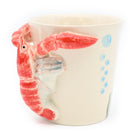 Ceramic mug with a red shrimp design on a white background