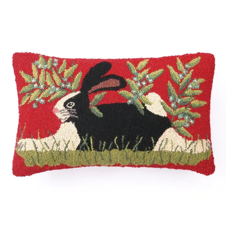 Decorative pillow with a rabbit design on a red background
