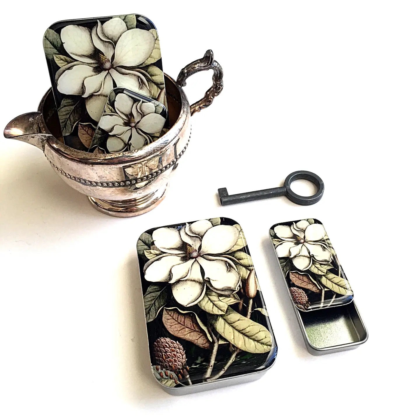 Decorative tins with floral design on a white background