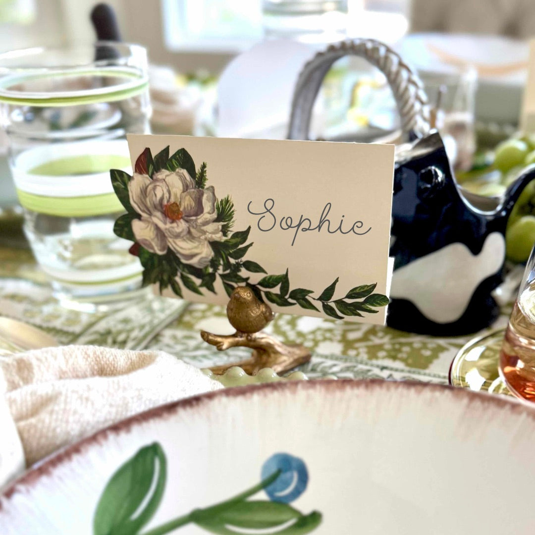 Table setting with a decorative name card featuring floral design and the name 'Sophie'.