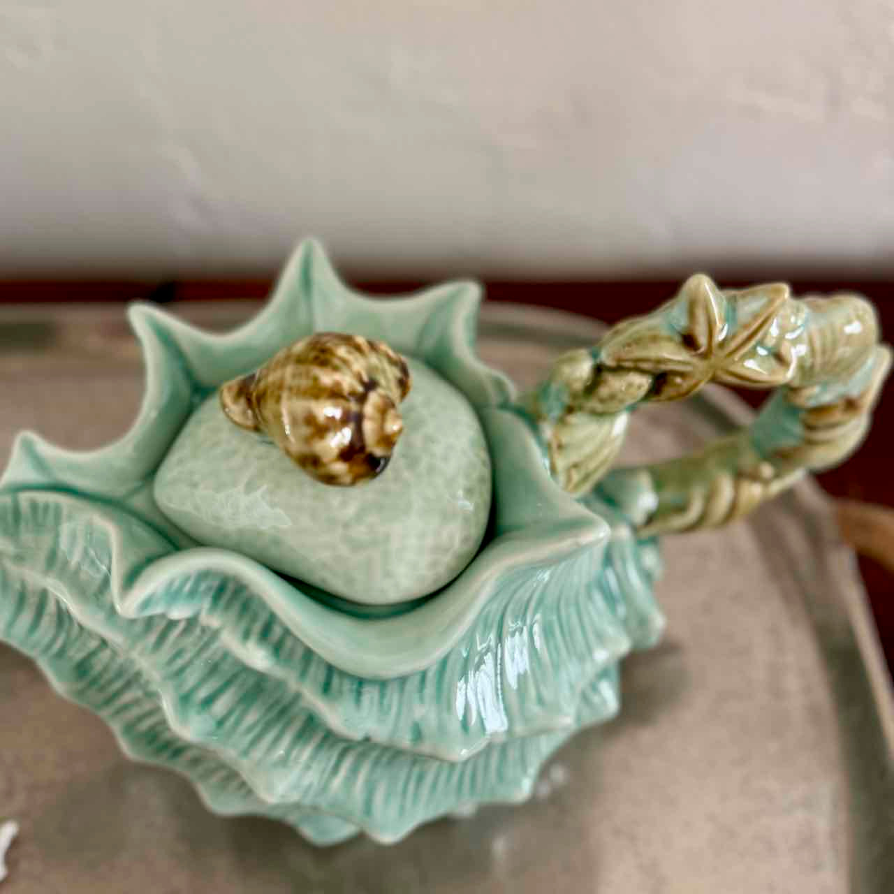 Decorative ceramic shell with a gold shell on a neutral background