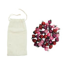 Decorative string of pink and red glass beads with a white drawstring bag on a white background