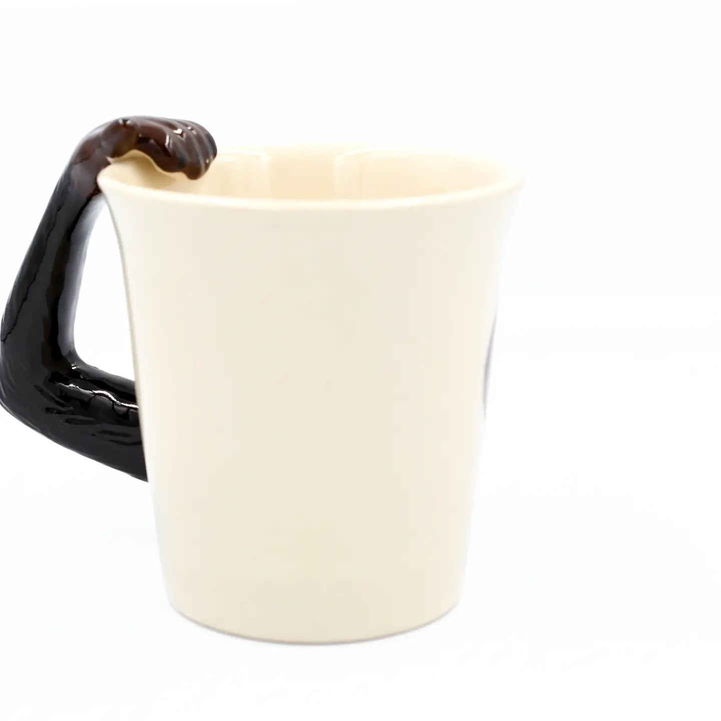 White mug with a black handle on a white background