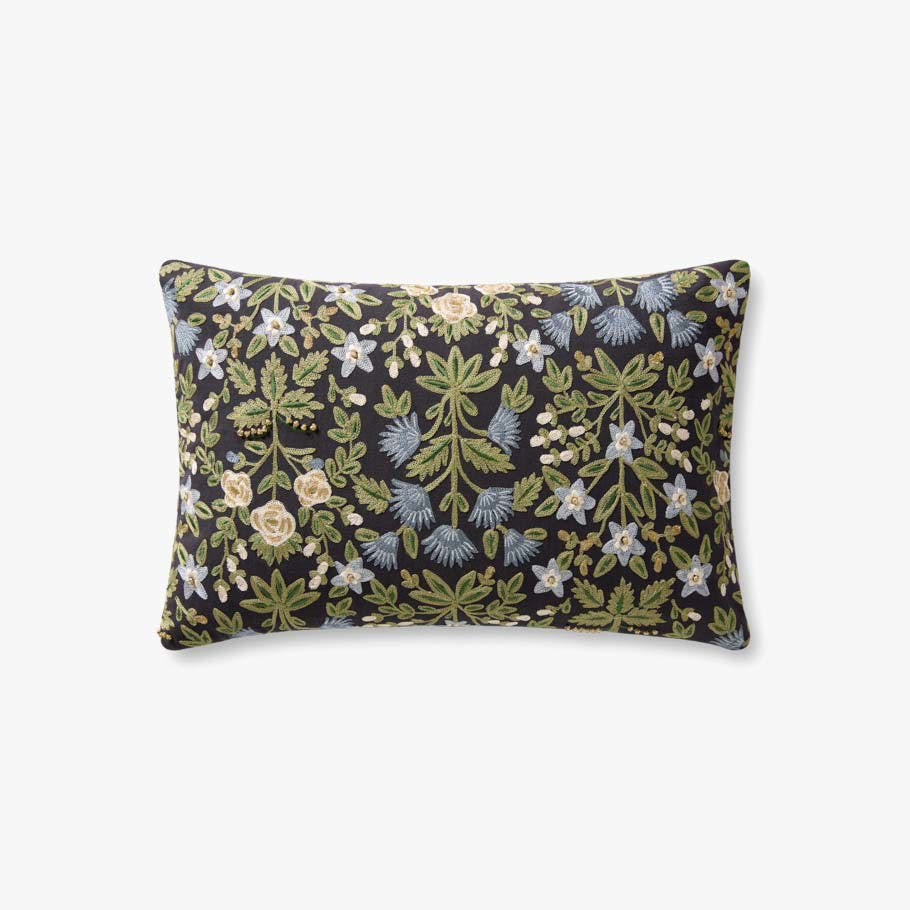A rectangular decorative throw pillow with a dense botanical floral pattern on a black background, featuring green leaves, light blue flowers, and cream roses, shown against a plain light gray background.