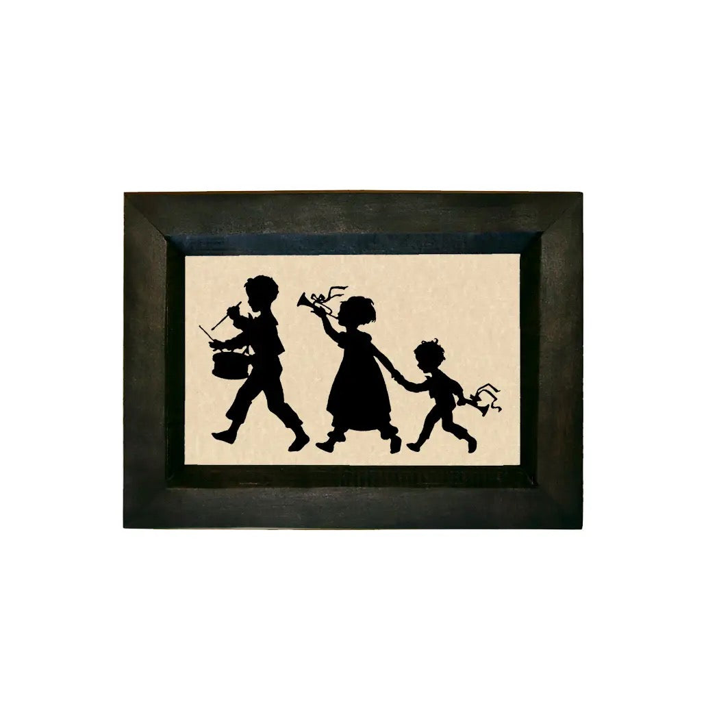 Framed silhouette art of three children holding hands on a beige background