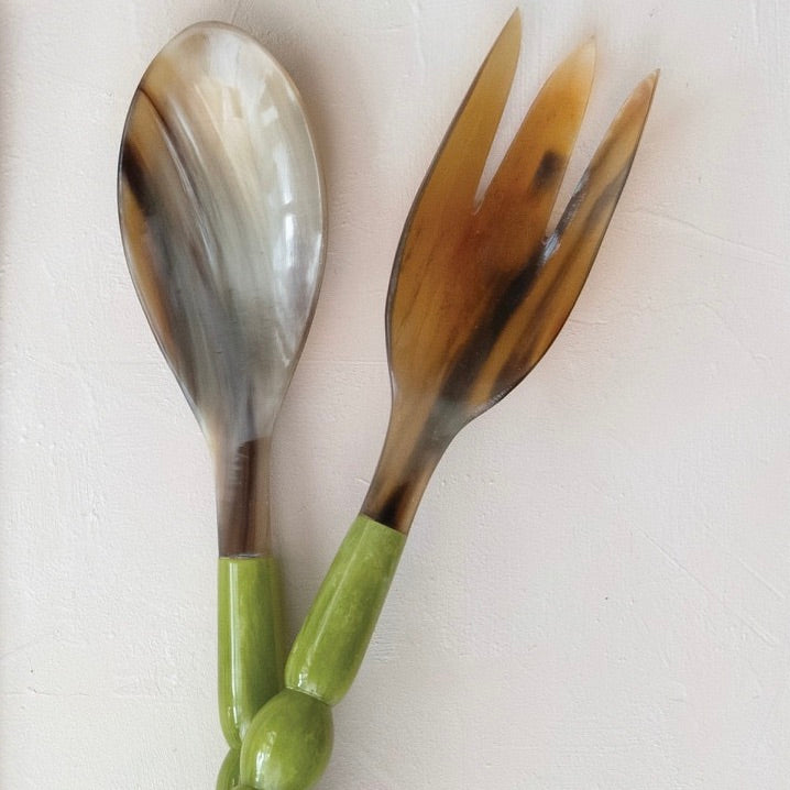 Spoon and fork with tortoiseshell handles on a white background