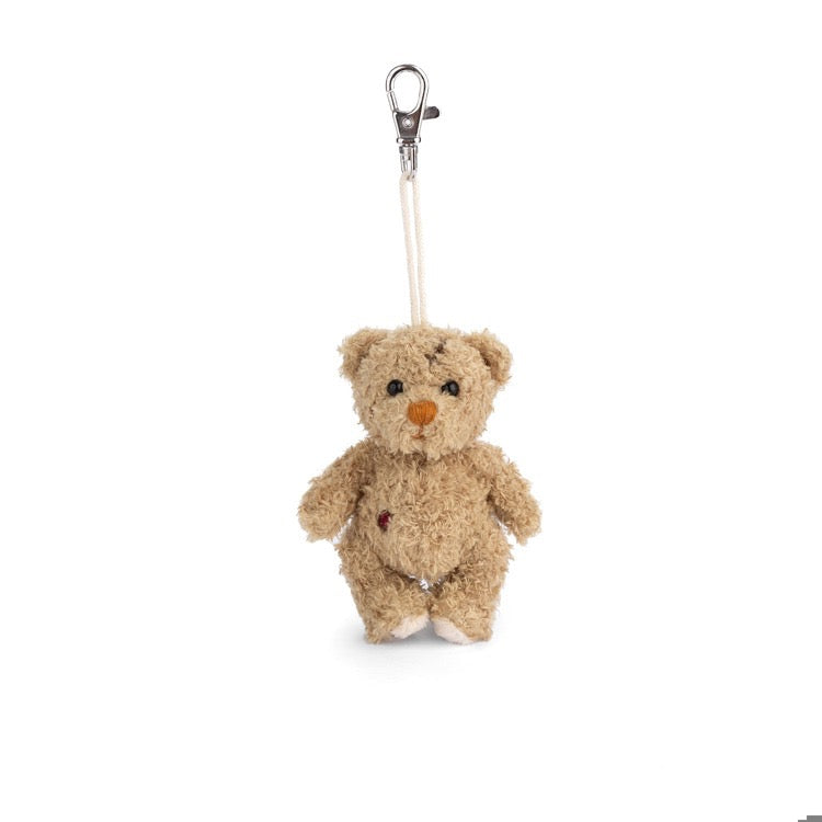 Small teddy bear keychain with a clip on a white background