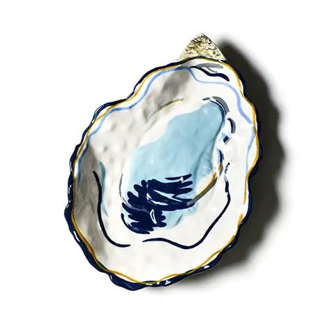Decorative ceramic oyster shell with blue design on a white background