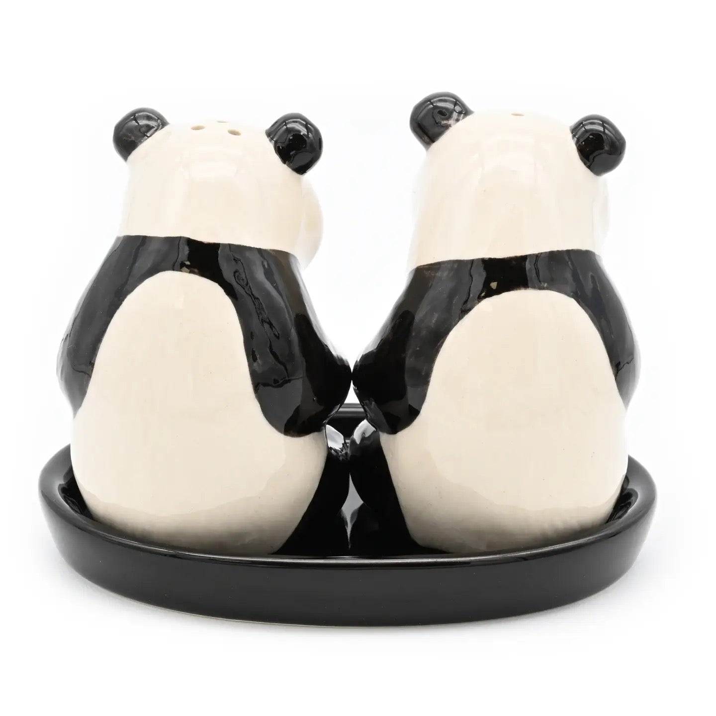 Panda-shaped salt and pepper shakers on a black base with a white background