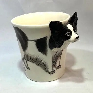 Ceramic mug with a black and white dog design on a white background