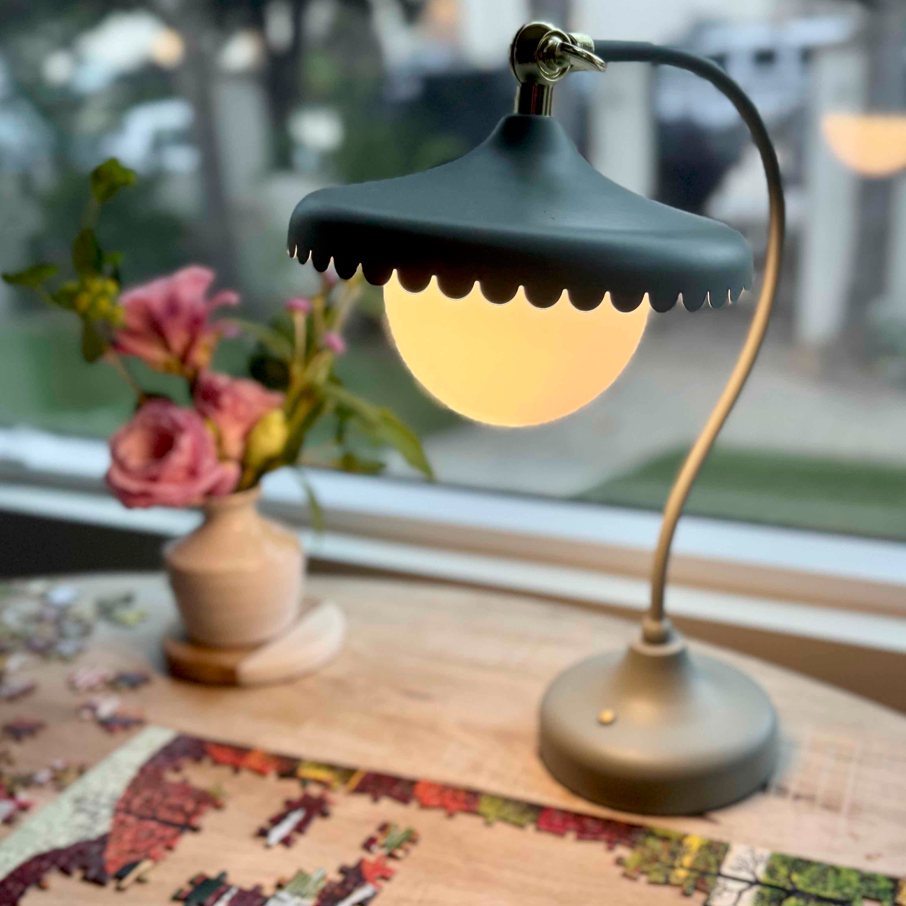 Vintage-style table lamp on a wooden surface with a blurred background