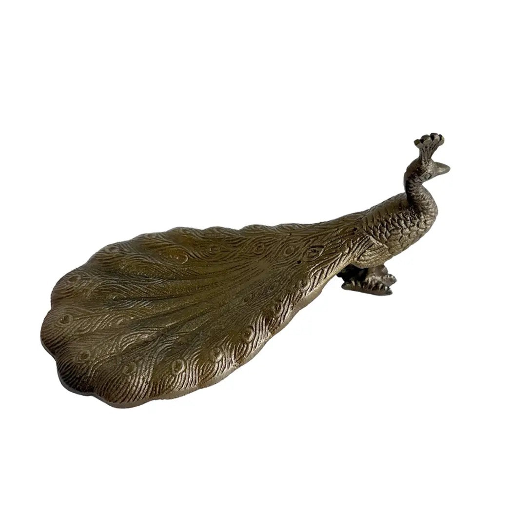Bronze peacock sculpture on a white background
