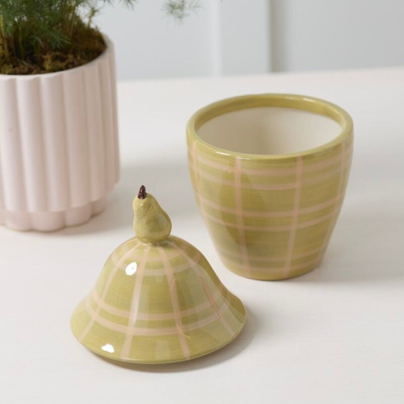 Two ceramic planters with a checkered pattern on a white surface.