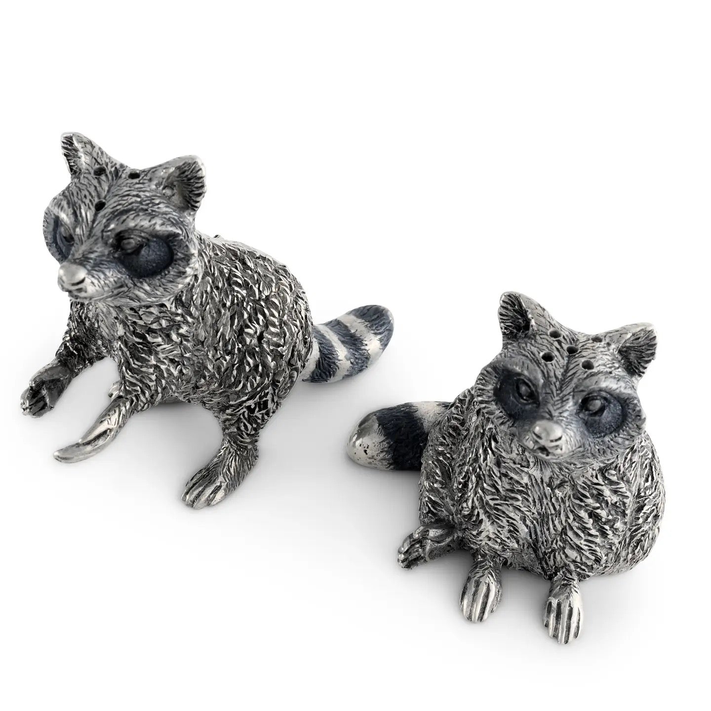 Two silver raccoon figurines on a white background