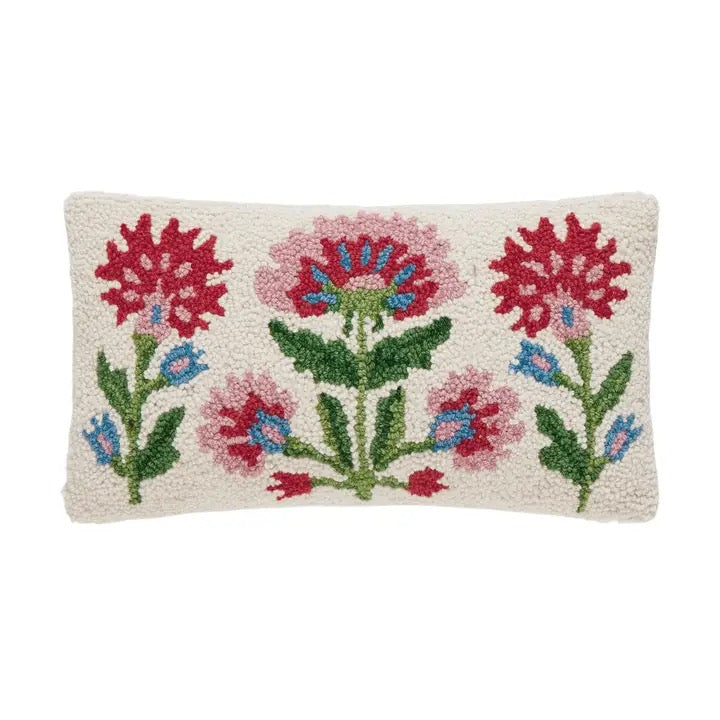 A rectangular hand-hooked wool pillow with a cream-colored base and a colorful floral pattern featuring red, pink, blue, and green flowers and leaves.