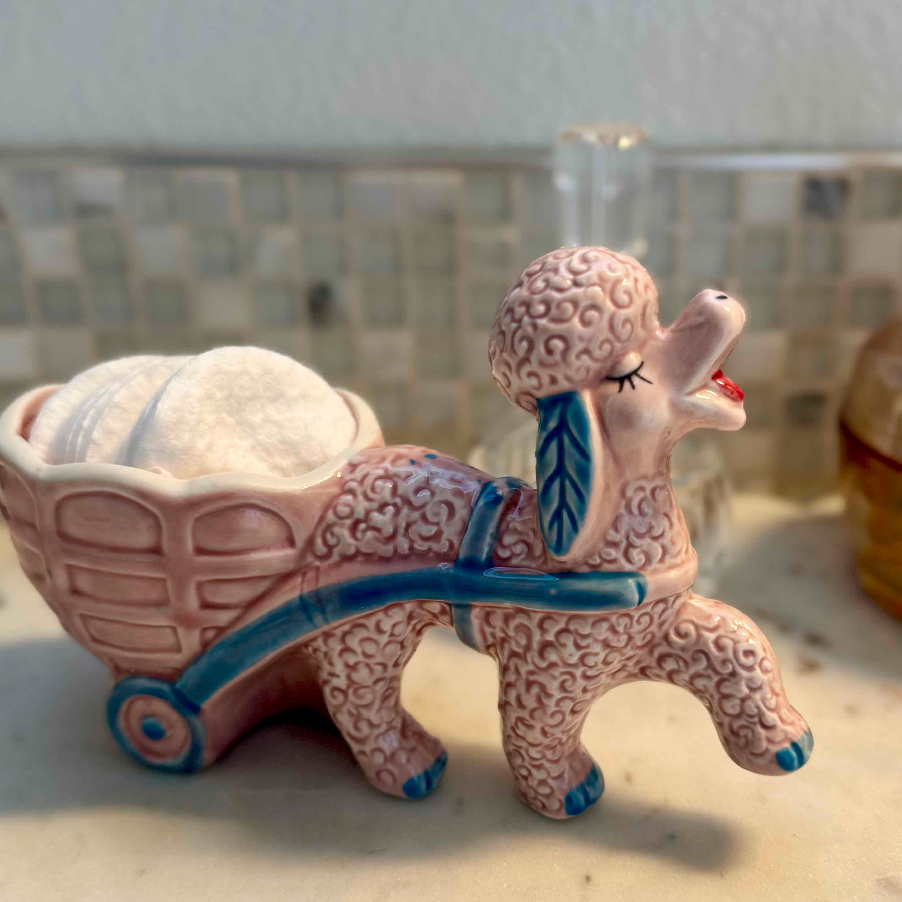 Ceramic llama figurine with a cart on a countertop