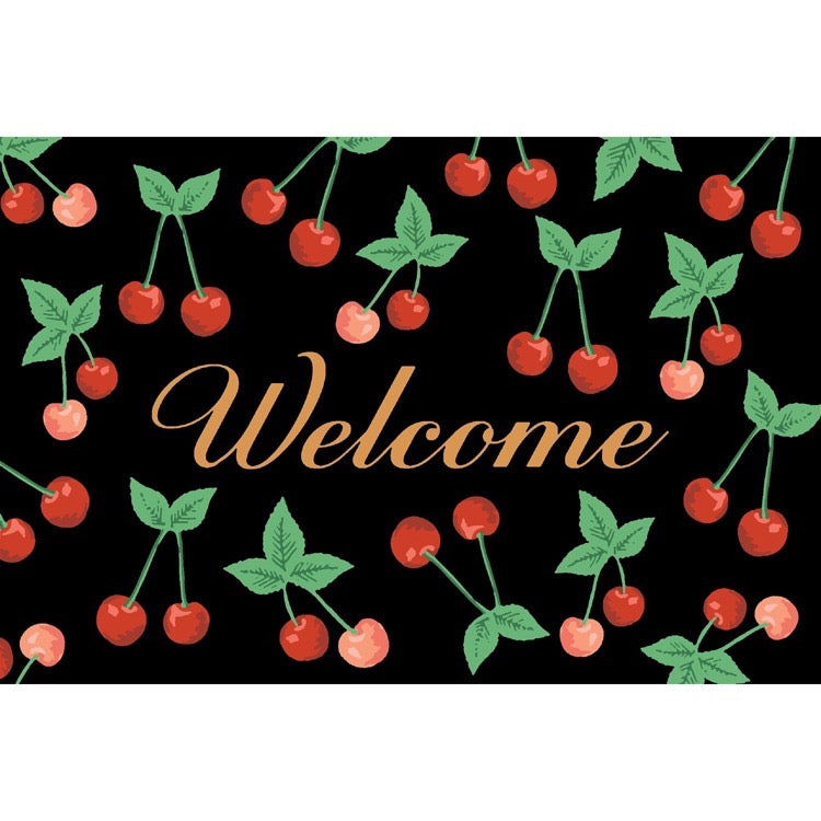 Welcome mat with cherry design on a black background