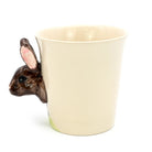Ceramic mug with a rabbit-shaped handle on a white background