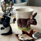 Mug with a rabbit design on a table with decorative items