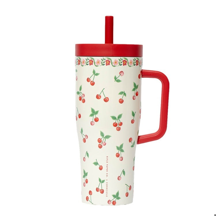 Tumbler with cherry pattern and red handle on a white background
