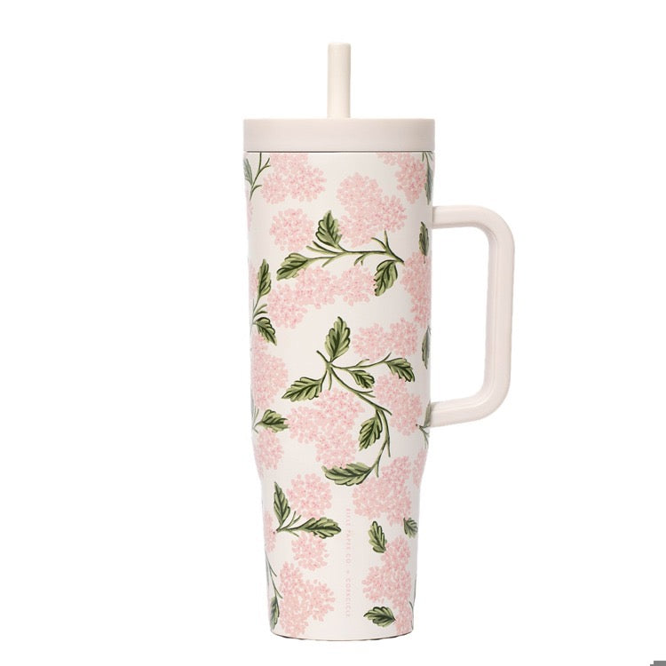 Floral-patterned tumbler with a handle on a white background