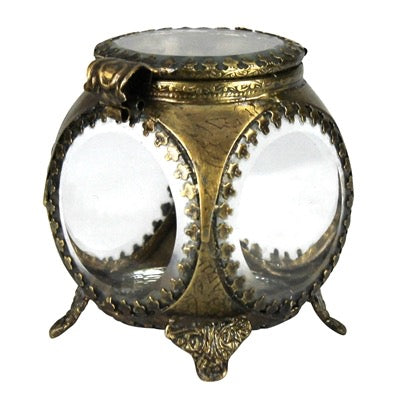 An ornate antique-style brass or bronze decorative object with three clear glass domes and small feet, shown on a plain white background.