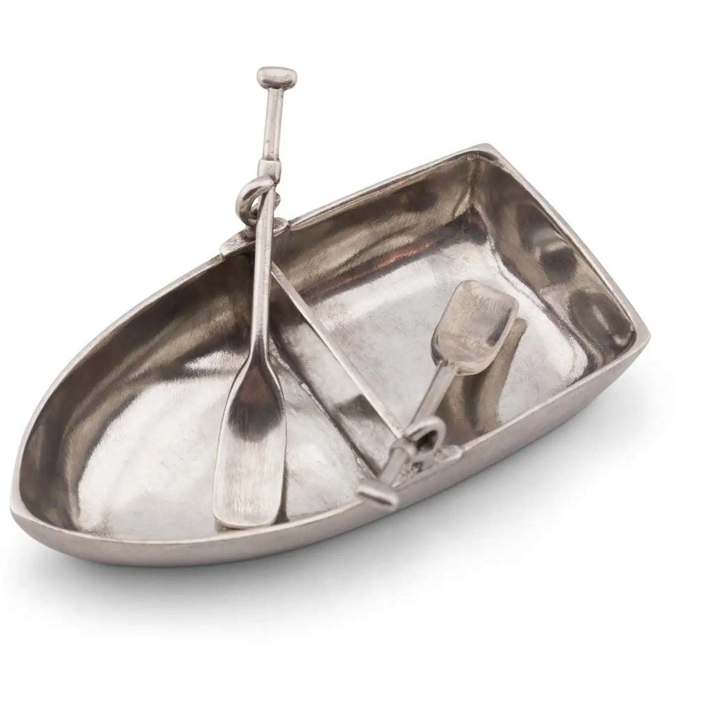 Metallic boat-shaped container with utensils on a white background